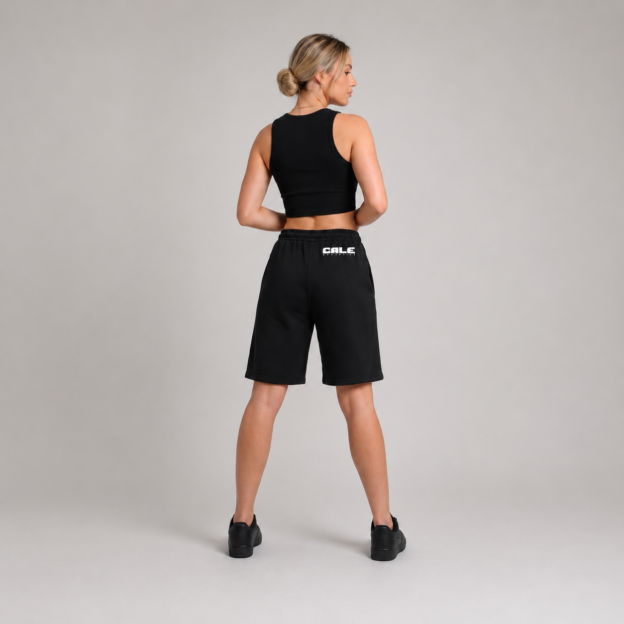 Black premium streetwear shorts with an elastic waistband and drawcord, styled for a relaxed fit.