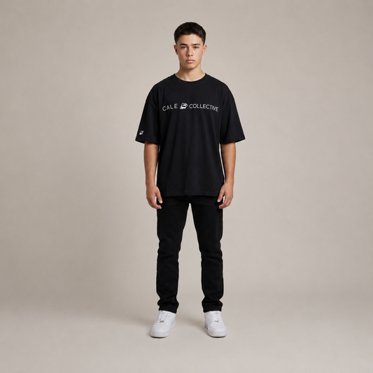 Black oversized graphic t-shirt worn by a model, featuring a relaxed fit, short sleeves, and crew neckline.