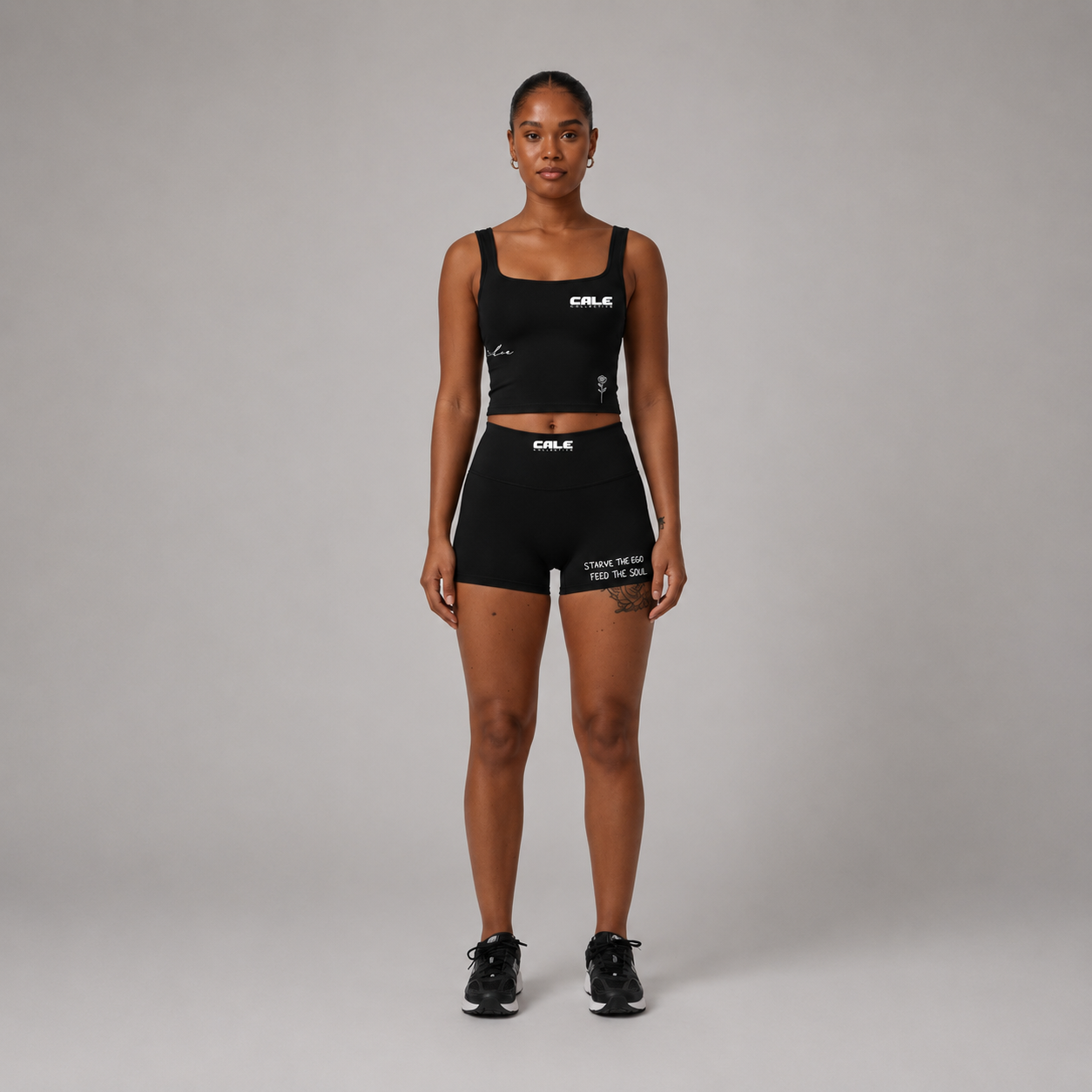 Model wearing black pocket shorts with a fitted shape and side pockets, styled with a matching black crop top.