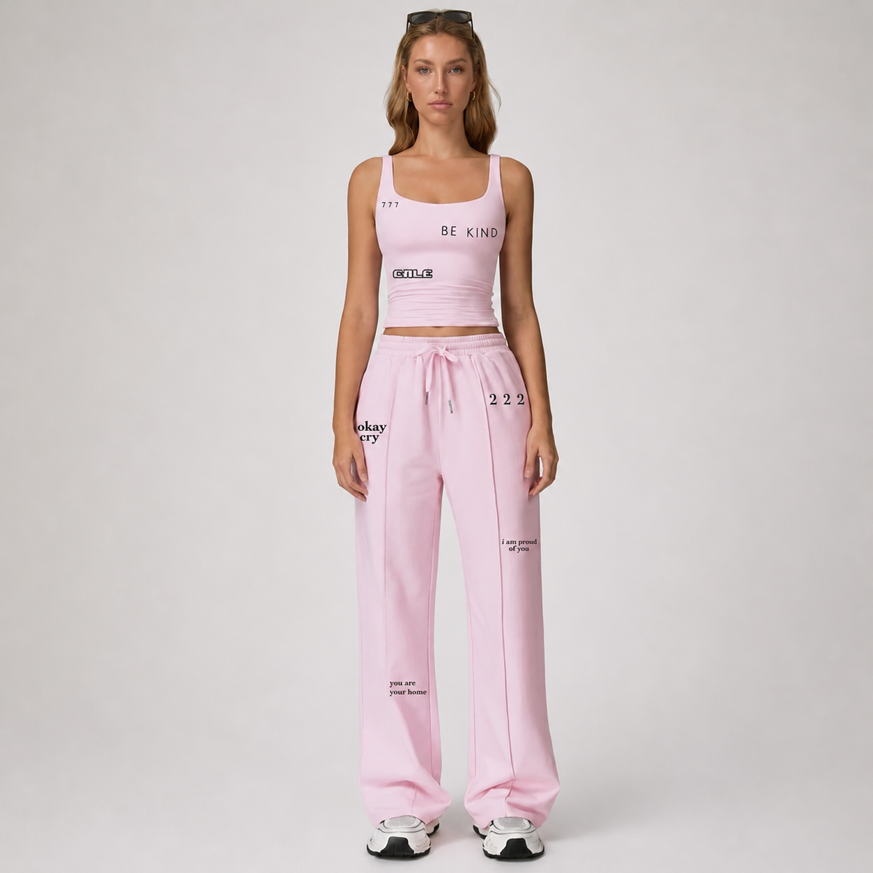 Pink fitted tank top with square neckline and thin straps, paired with matching pink pants, showcasing a flattering fit.