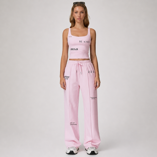 Pink fitted tank top with square neckline and thin straps, paired with matching pink pants, showcasing a flattering fit.