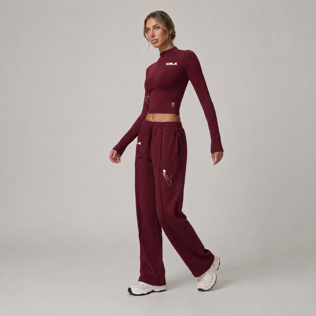 Burgundy fitted long sleeve crop top with high neckline, styled with matching burgundy pants. Soft and stretchy fabric.