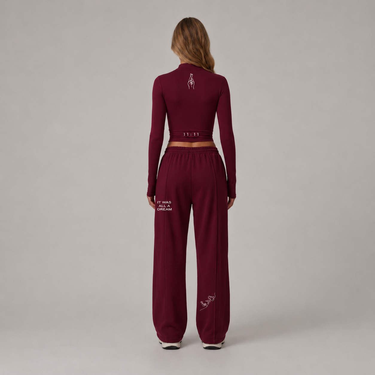 Fitted burgundy long sleeve crop top styled with matching loose-fitting pants, showcasing a soft and stretchy fabric.